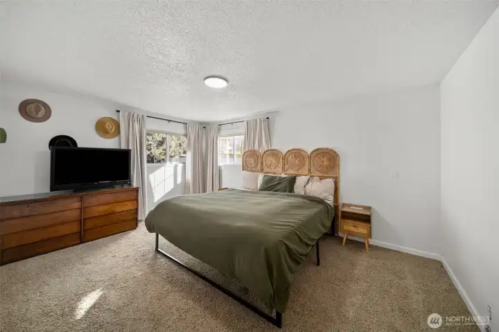 Bedroom 1 with generous floor area (king bed for reference)