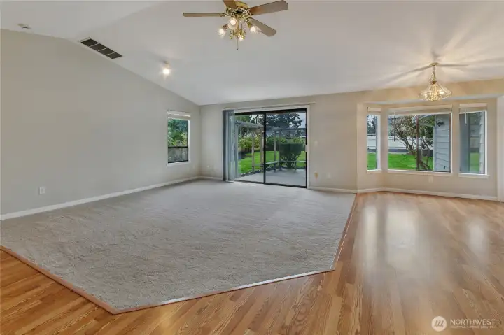Kitchen and dining area are all-wood and transition easy to freshly carpeted Great Room.