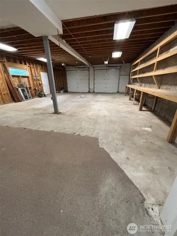 Additional 4 car garage with additional storage rooms and workbenches.