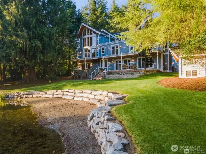 Professionally Designed rockery wall and rare sand beach.