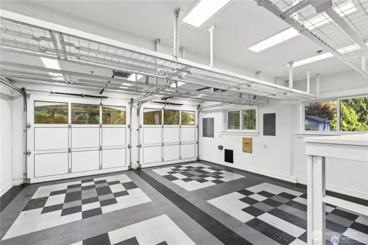 Oversized Garage with custom garage doors. Race Deck High Density Polyurethane floating tile flooring. Storage Racks above and floor level large shelving.