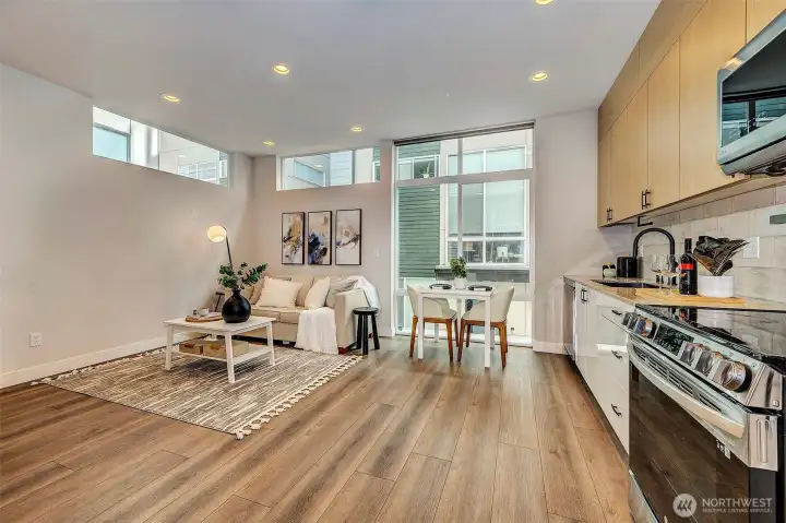 Expansive windows invite abundant natural light, while custom shade blinds throughout offer enhanced comfort and privacy.