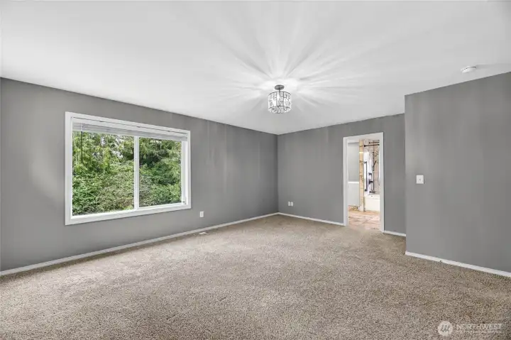 REMODELED PRIMARY SUITE  Large bedroom with views of serene rear yard