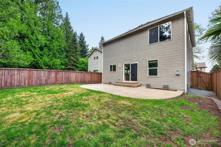Fenced rear yard with gates on both sides