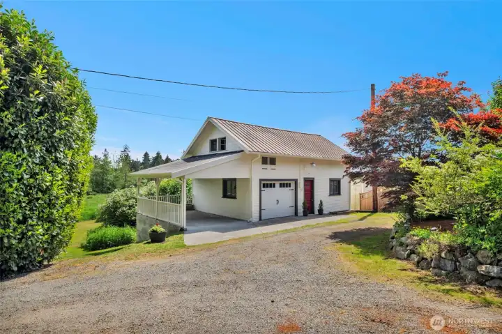 Covered parking and 1 bay garage with shop space.