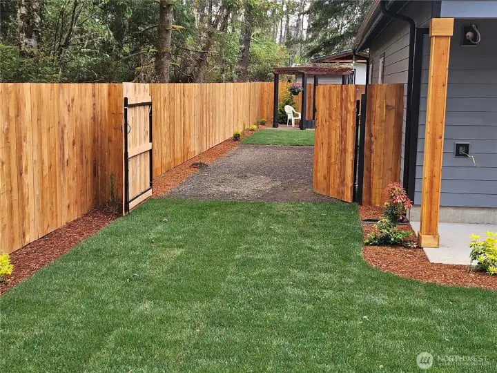 Double gates at the side of the house open to the graveled area for your RV or boat. Double gates at the side of the house open to the graveled area for your RV or boat.