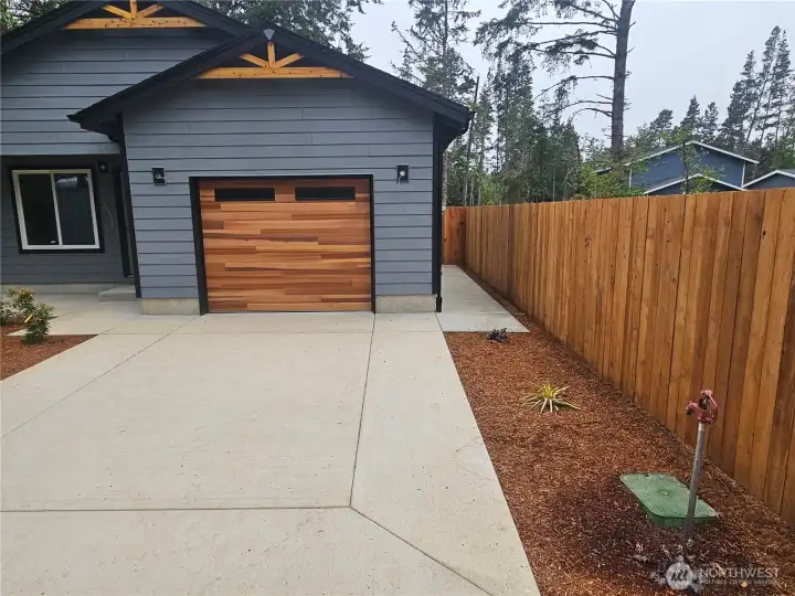 Cement driveway and sidewalk to the covered front porch and on the right to the garage side door. Cement driveway and sidewalk to the covered front porch and on the right to the garage side door.