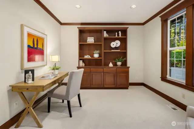 The large office on the main floor has quality built-ins and room for two large desks.