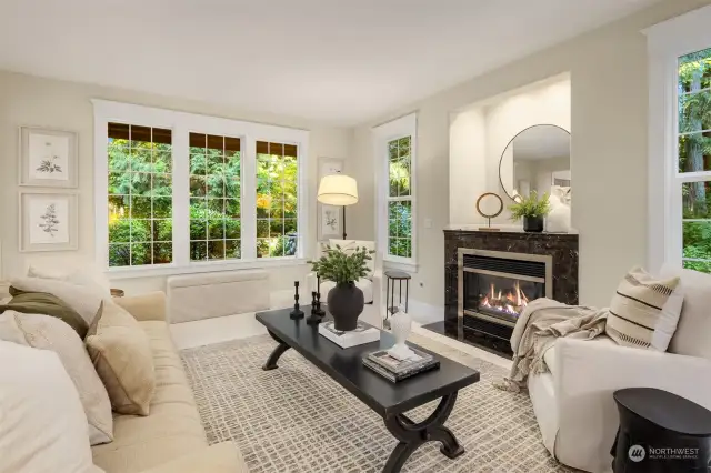 The living room is large and welcoming. The large windows overlook the gardens.