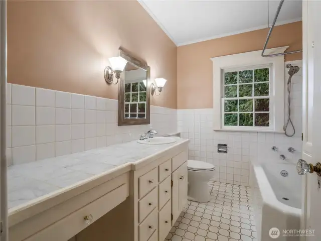 Full upstairs bathroom with restored cast iron tub.