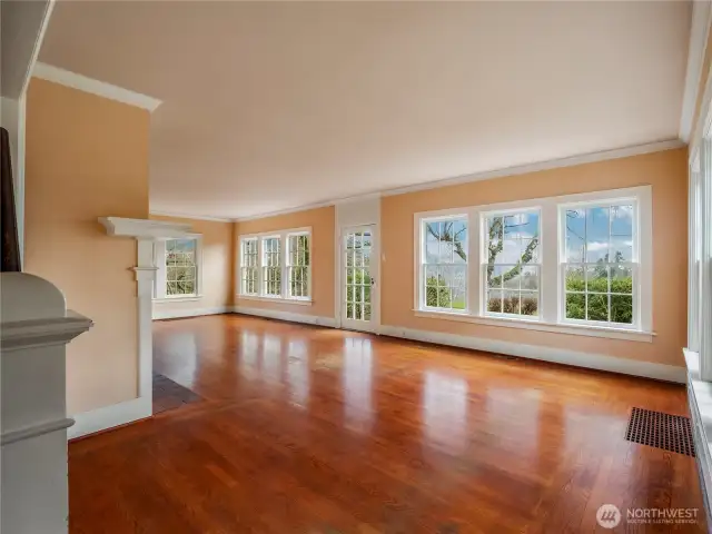 Enter the house to the original white oak hardwood floors, currently stained in a walnut shade. Story-book windows look east to the water view and beautiful sunrises.