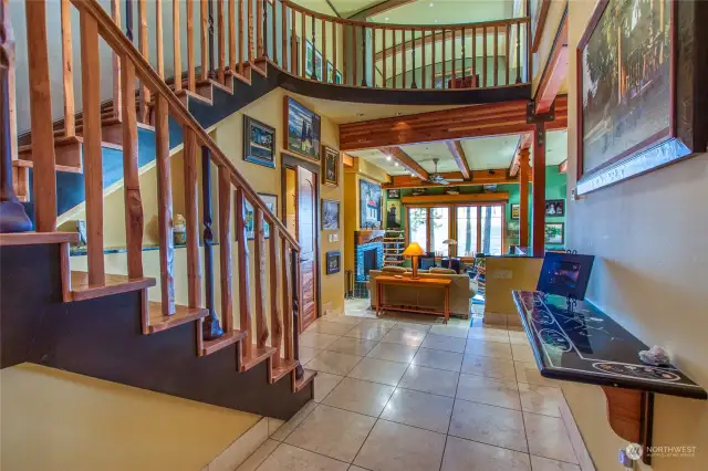 The foyer offers stairs ascending to the second floor media / office area + bedrooms while the kitchen is to the right and living / dining space is straight ahead. Primary suite and guest bath is to the left.