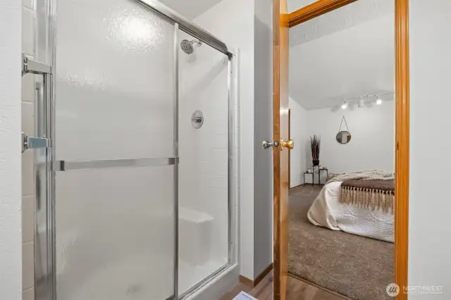 Full bath off primary bedroom with shower and soaking tub.