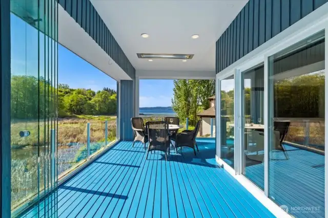 Covered Deck with built in heaters and retractable glass panels for complete encloser during cold nights.