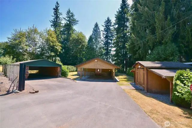 Gated entry, extra covered parking and storage shed towards front of property. Yard is fully fenced to protect littles and animals from direct access to river.