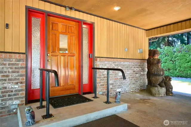 Solid wood Entry door with deadbolt. Washed  Brick inlay. Concrete car port floor. Concrete walkways to the spacious patio in the pack. the side yards are like a park area with privacy trees.