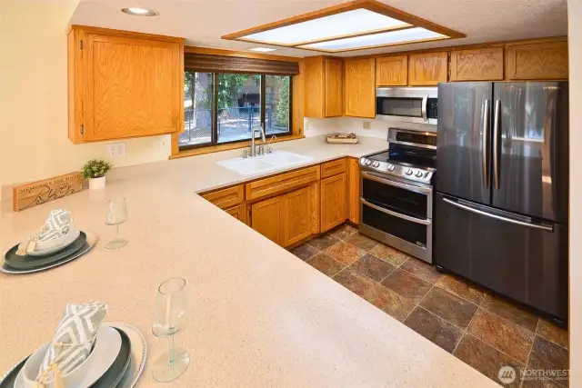 Gorgeous views of the river from the kitchen window. Open kitchen with eating bar, oak cabinets,walk-in-pantry, like new upgraded appliances all stay, LG double oven, Samsung refrigerator, Bosch dishwasher, and microwave. v