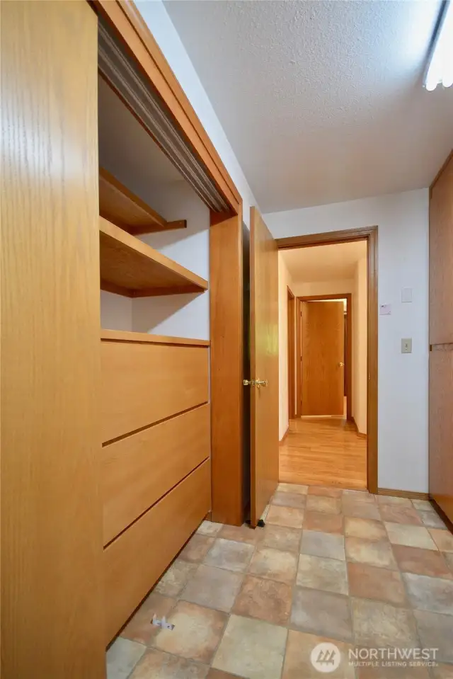 Storage built ins in the laundry room with cabinets above the washer and dryer. this home has plenty of storage areas.