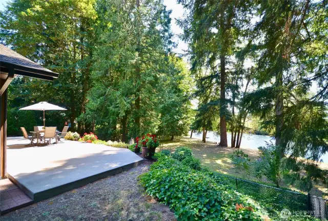 Large concrete patio perched above, overlooking 109 feet of Nisqually River frontage, garden space available, low bank!