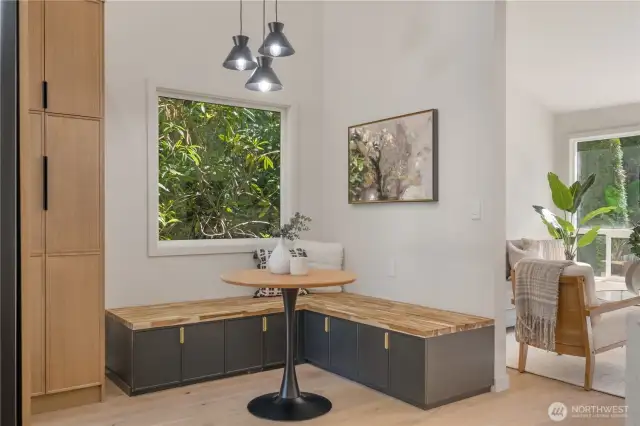 Custom bench seating area offers a cozy casual eating space.  Large pantry storage.