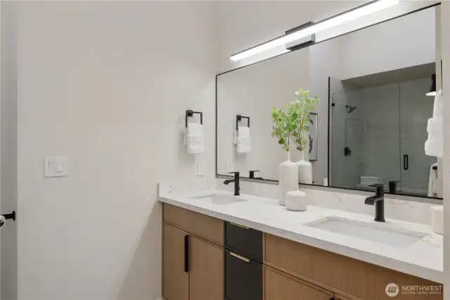 Dual sink vanity & porcelain tile floors.