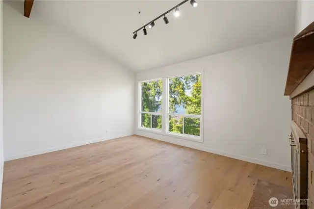 Large den with fireplace and beautiful lake views.