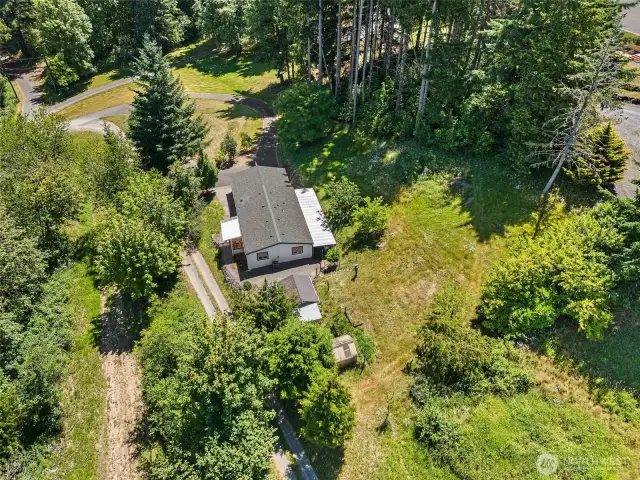 Bird’s-eye view of the former garden space, upper yard, and cherry tree—plenty of room to garden, play, or create your dream outdoor retreat.