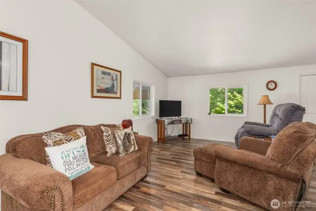 With vaulted ceilings, natural light, and an open layout, this living room is perfect for hosting guests.