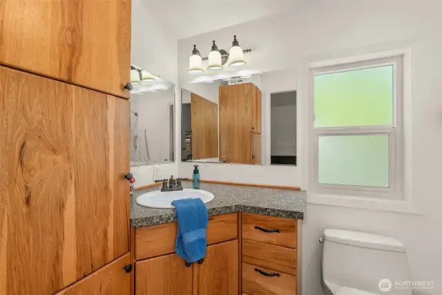 The primary bath includes beautifully upgraded cabinetry for a polished, functional space.