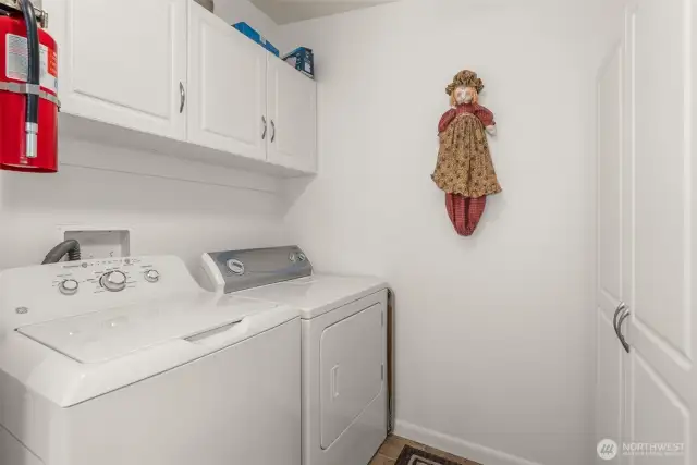 Functional laundry room with exterior door and pass-through bath for easy indoor-outdoor living. The added storage is a bonus too!