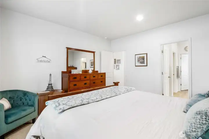 Another view of the primary bedroom shows you the way into the bathroom.