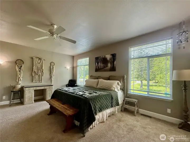 Picture windows overlook beautiful landscaping and green space.