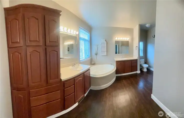 Ensuite bath in Primary suite with soaking tub, two sinks and separate shower.