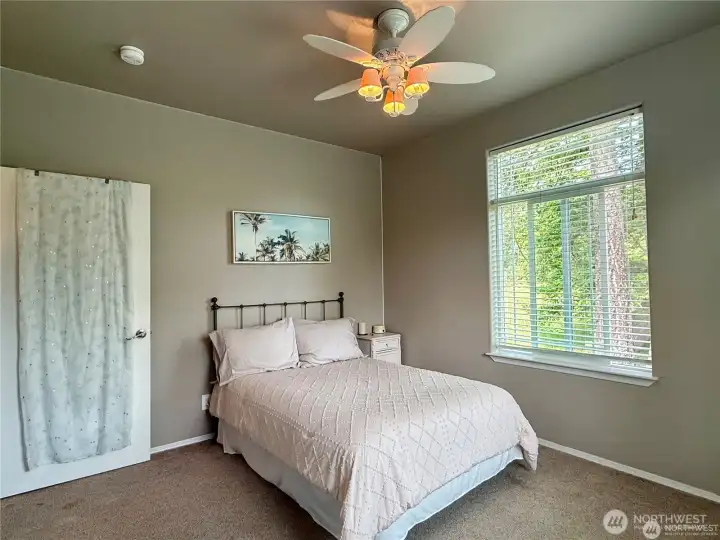 Bedroom two bright and sunny with large picture windows.