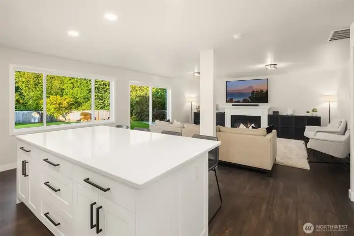 Enjoy the 4x8 ft kitchen island with bar seating adorned in sparkling quartz counters