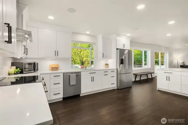 Notice the new stainless steel Bosch appliances including dishwasher, refrigerator, glass top range and matching hood vent. Even the extra deep sink is made from scratch resistant stainless steel, and it's matching faucet is hands free.