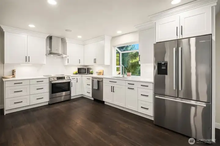 Classic subway tile and custom, European style cabinetry hang proudly accented by dimmable under cabinet lighting. The pantry is just as impressive with wood countertops.
