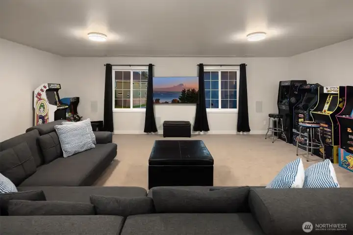 This theater room features a ceiling mounted projector with remote control, a retractable 132" screen and theater quality 7.1 surround system.