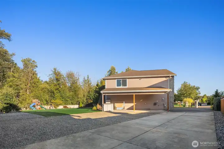In addition to the tandem 4 car garage, this home offers a covered carport and RV/boat parking beyond it's iron gate. The garage has its own sink basin, and is wired for a generator.
