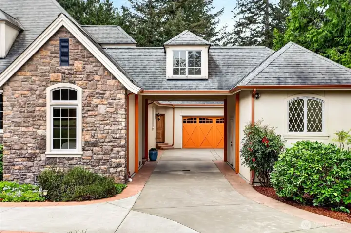 Drive under portico gives access to a 2 Car Garage, A Single Garage/Shop and a standalone 4 Bay Garage