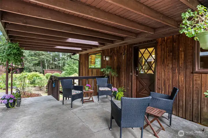 covered patio off kitchen, great for gathering during lazy days of summer