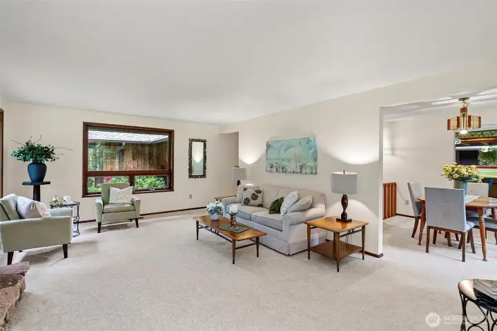 Living room is bright and inviting with views of mature landscaping from every windo