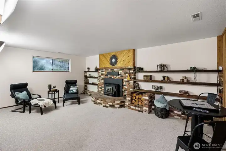 Large family room with wood stove in finished basement