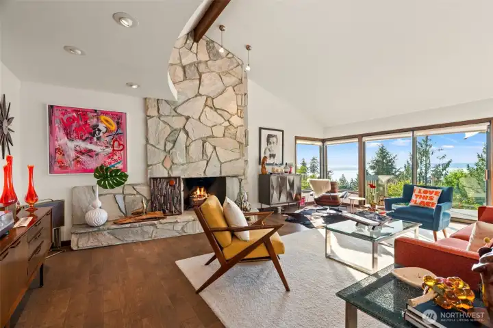 Living room with vaulted ceiling, custom fireplace and oversized windows to take in the Sound and Mountain views.
