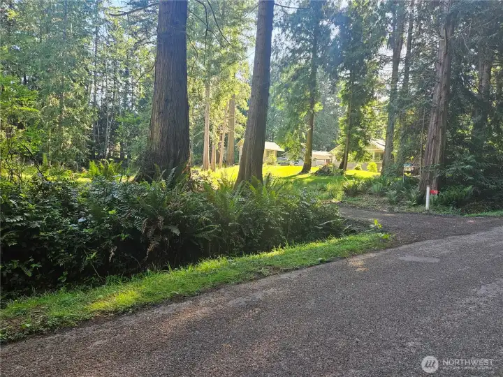 Driveway entry to property with address marker