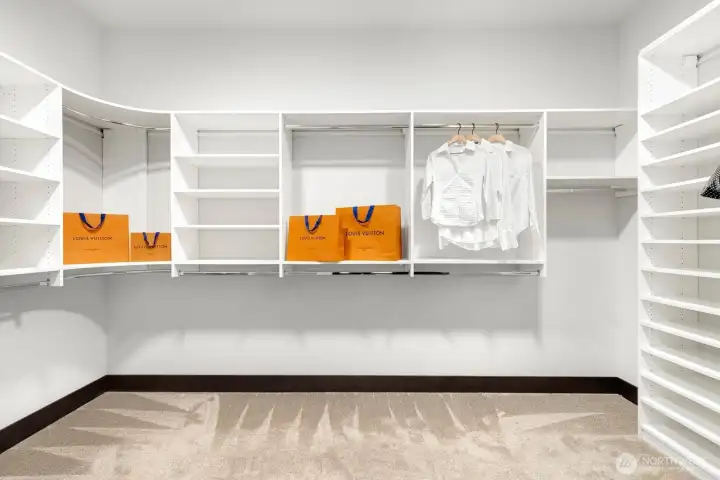 Spacious primary closet with built-ins Spacious primary closet with built-ins
