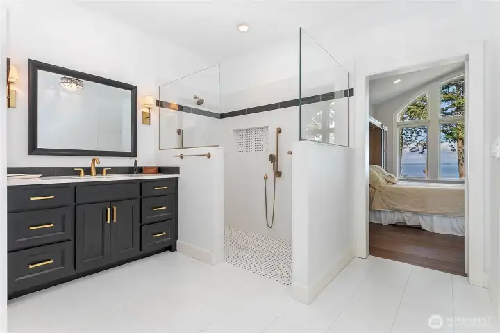 Primary bathroom with separate sinks and walk in closet