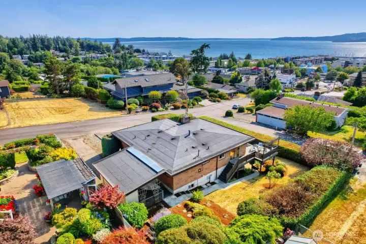 Aerial View of Home and Puget Sound Setting This stunning aerial perspective captures the home’s prime location overlooking Puget Sound. The mid-century architecture stands out amid lush landscaping and manicured hedges, with the elevated deck offering sweeping water and mountain views. Nestled in a quiet, established neighborhood, the property combines privacy with proximity to local amenities and waterfront charm—perfect for enjoying the beauty of the Pacific Northwest. Aerial View of Home and Puget Sound Setting This stunning aerial perspective captures the home’s prime location overlooking Puget Sound. The mid-century architecture stands out amid lush landscaping and manicured hedges, with the elevated deck offering sweeping water and mountain views. Nestled in a quiet, established neighborhood, the property combines privacy with proximity to local amenities and waterfront charm—perfect for enjoying the beauty of the Pacific Northwest.