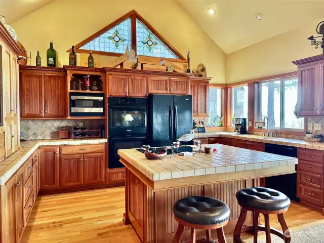 The kitchen is large and spacious with windows to maximize the view and is open to the Great Room and access to the expansive deck.  An entertainer’s dream!