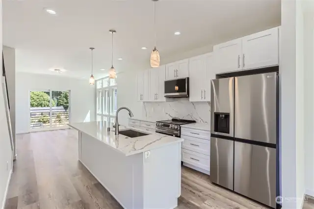 18331 - Actual Kitchen with custom quartz countertops, SS appliances, generous island with seating for 5.